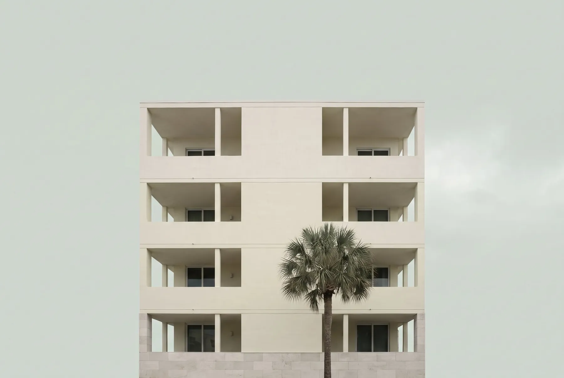 Holly Street Lofts facade with a deep shaded porch and a tree in front